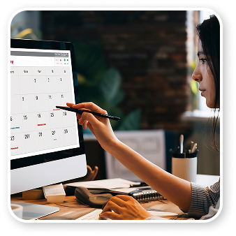 Woman using calendar interface on desktop computer